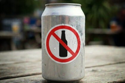 Lata de cerveja ao lado de martelo de juiz representando debate sobre publicidade de bebidas alcoólicas no Brasil